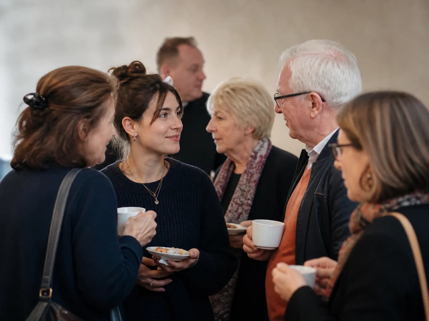 Family and friends sharing tea and quiet conversation together